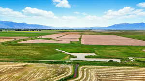 View of rural area featuring extensive farmland and a mountain backdrop