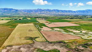 View of rural area featuring extensive farmland and a mountain backdrop