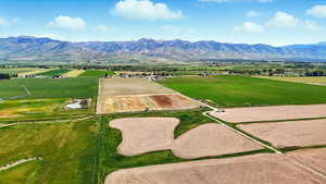 Overview of rural landscape with extensive farmland and a mountainous background