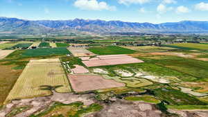 View of rural area featuring a mountainous background and farmland