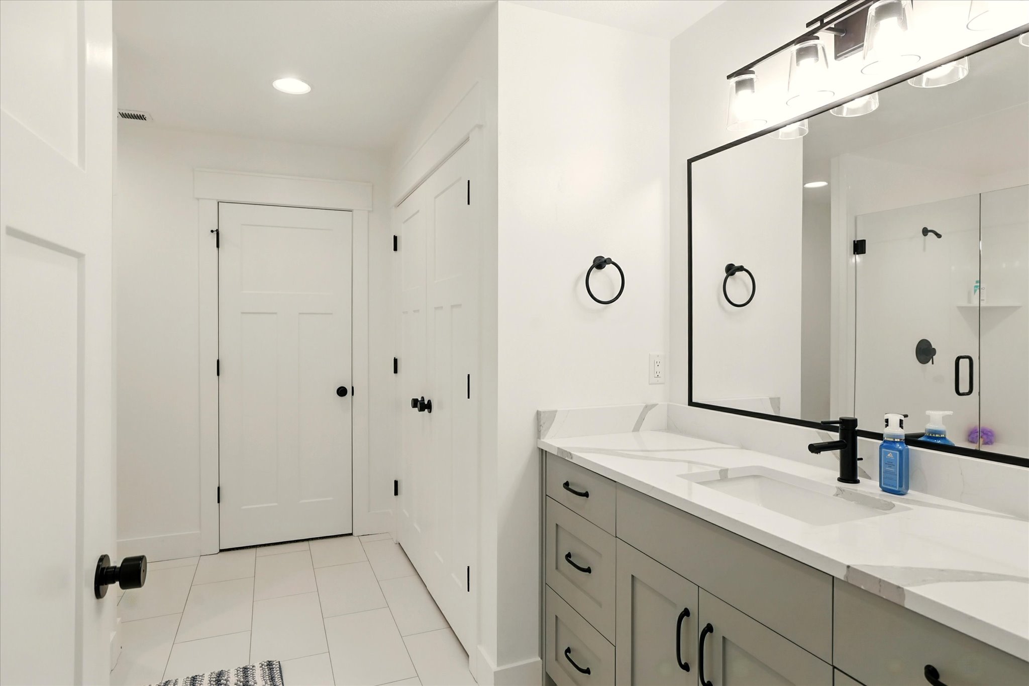 Bathroom featuring vanity, light tile patterned floors, recessed lighting, and a shower stall