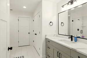 Bathroom featuring vanity, light tile patterned floors, recessed lighting, and a shower stall