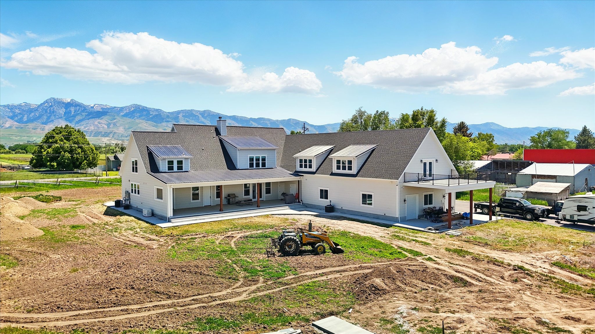 Back of property with a mountain view, a patio, and a chimney
