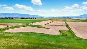 View of rural area featuring extensive farmland and a mountain backdrop
