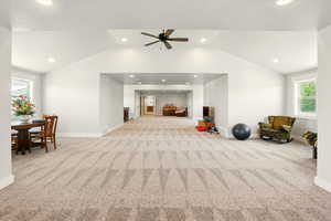 Bonus room with plenty of natural light, light carpet, lofted ceiling, recessed lighting, and ceiling fan