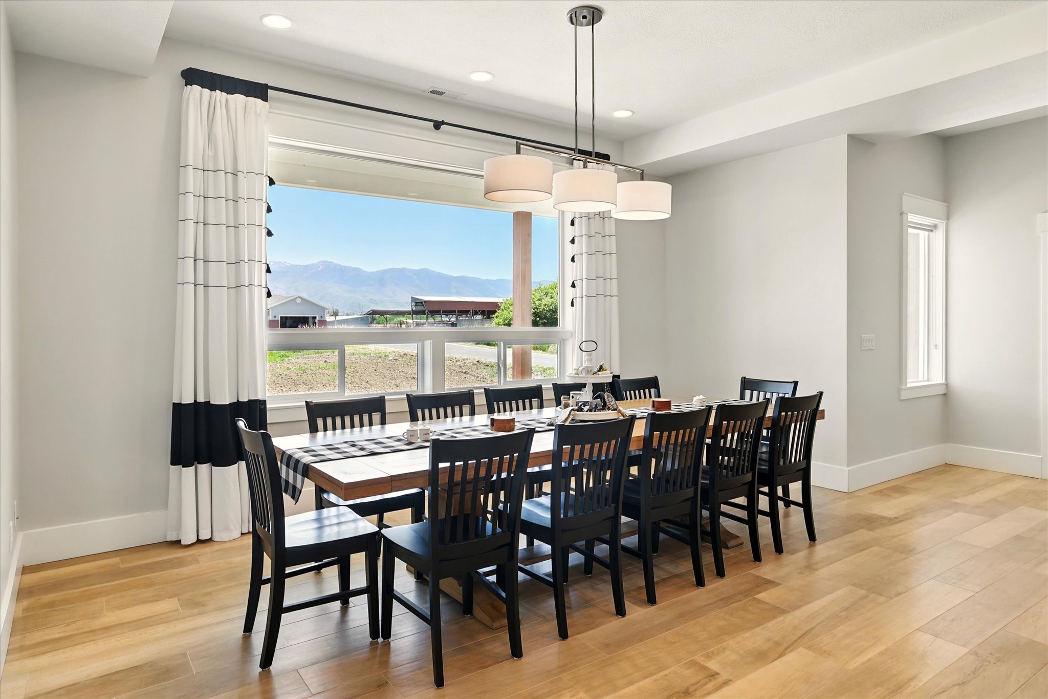 Dining area featuring a mountain view, light wood finished floors, and recessed lighting