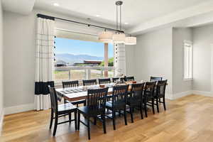 Dining area featuring a mountain view, light wood finished floors, and recessed lighting