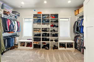 Walk in closet featuring light carpet