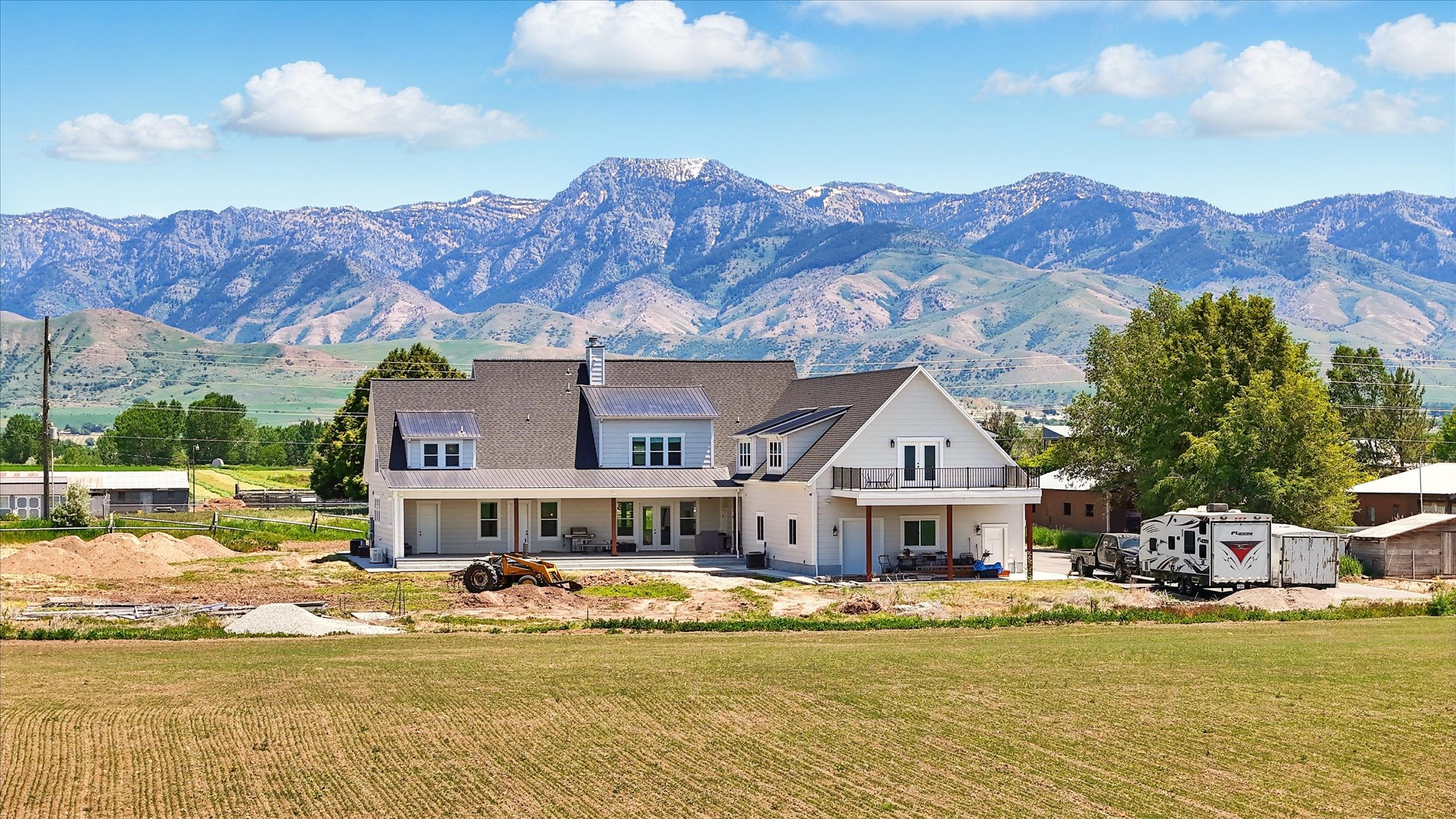 View of back of home, lower porch, upper deck and Mountain views