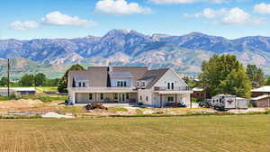 View of back of home, lower porch, upper deck and Mountain views