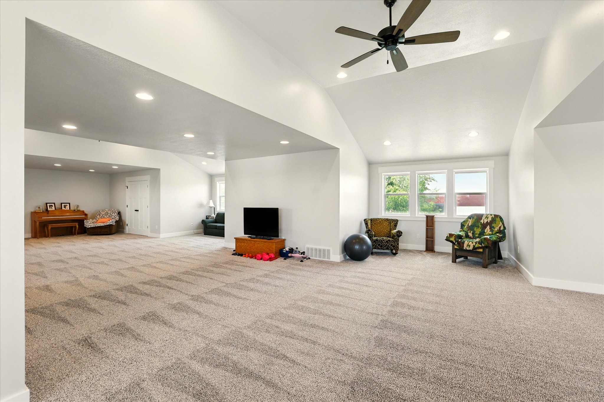 Rec room with recessed lighting, light colored carpet, lofted ceiling, and ceiling fan