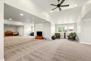 Rec room with recessed lighting, light colored carpet, lofted ceiling, and ceiling fan