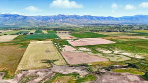 Aerial view of sparsely populated area featuring abundant farmland and a mountain backdrop
