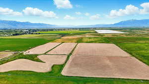 Overview of rural landscape with extensive farmland and a mountainous background