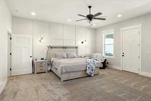 Carpeted bedroom featuring recessed lighting and a ceiling fan