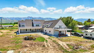 View of back of home, lower porch, upper deck and Mountain views