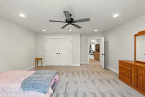 Bedroom featuring recessed lighting, light colored carpet, a closet, and a ceiling fan