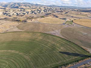 Aerial view of property and surrounding area with rural landscape and a mountain backdrop