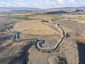 Aerial view of property and surrounding area featuring mountains and rural landscape