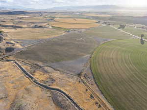 Aerial overview of property's location with rural landscape and mountains
