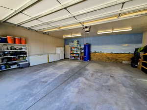 Garage featuring freestanding refrigerator