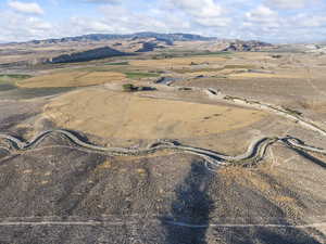 Aerial overview of property's location with a mountain backdrop and rural landscape