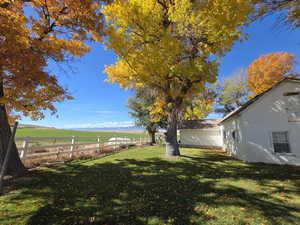 Fenced backyard featuring a view of rural / pastoral area and a mountain view