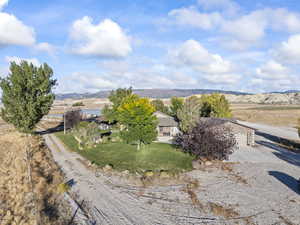 Aerial view of property and surrounding area with a mountainous background