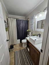 Full bathroom featuring vanity, ornamental molding, light tile patterned flooring, shower / bathtub combination with curtain, and a textured ceiling