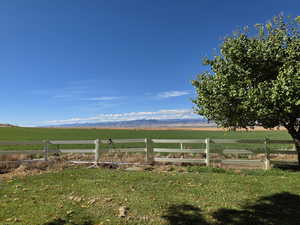 View of yard featuring a view of countryside, agricultural area, and a mountain view