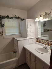 Full bathroom featuring a bath and vanity