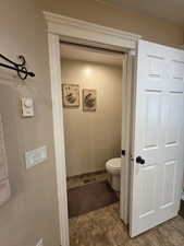 Bathroom with toilet and baseboards