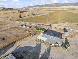 Aerial view of property and surrounding area with rural landscape and a mountainous background