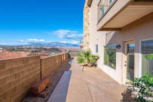 Patio / terrace with a mountain view and a fenced backyard