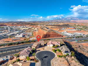 Aerial view of property and surrounding area with a mountain backdrop