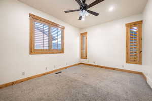 Unfurnished room featuring carpet flooring and a ceiling fan