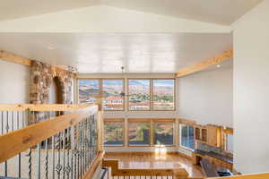 Unfurnished living room featuring light wood-style floors, a mountain view, and high vaulted ceiling