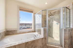 Full bathroom featuring a whirlpool tub, a shower stall, and recessed lighting