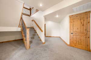 Stairs featuring carpet and recessed lighting
