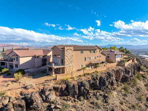 View of home's exterior with a balcony, a residential view, and a mountain view