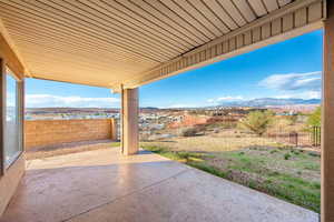 Fenced backyard with a mountain view and a patio area