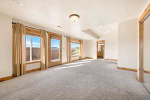 Empty room featuring healthy amount of natural light and light carpet