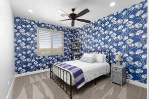 Bedroom featuring wallpapered walls, a ceiling fan, carpet, and recessed lighting