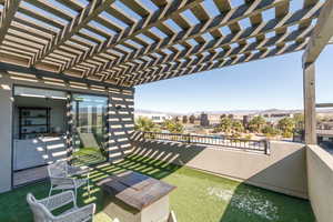 Balcony featuring a mountain view and a pergola