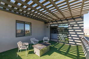 View of patio / terrace with an outdoor fire pit and a pergola