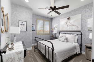 Carpeted bedroom featuring a ceiling fan, recessed lighting, and wallpapered walls