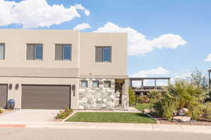 View of front of property with driveway, stucco siding, a front lawn, and a pergola