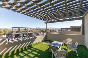 View of grassy yard with a patio area, a mountain view, and a pergola