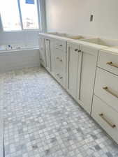 Bathroom with double vanity and a garden tub