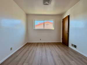 Unfurnished room featuring light wood-style flooring and baseboards